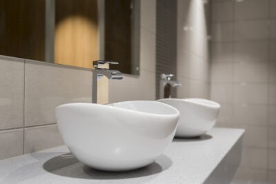 Two white bowl sinks in a bathroom.