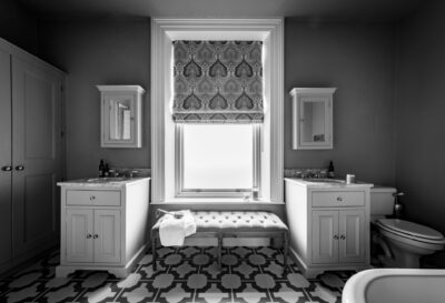 A black and white photo of a bathroom.