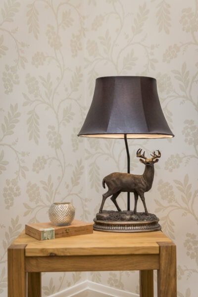 A table lamp with a deer on it.