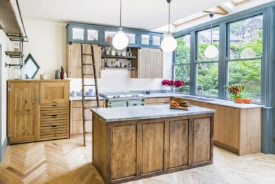 A kitchen with wooden floors and a wooden island.