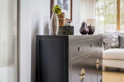 A black sideboard in a living room.