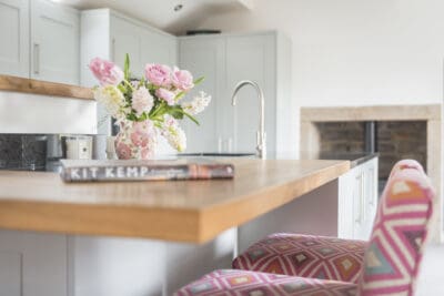 A kitchen counter with a vase of flowers.